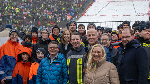 Ministerpräsident Boris Rhein, Landtagspräsidentin Astrid Wallmann, Sportministerin Diana Stolz und Kultusminister Armin Schwarz mit Freiwilliger Feuerwehr. In Hintergrund sieht man eine Skischanze