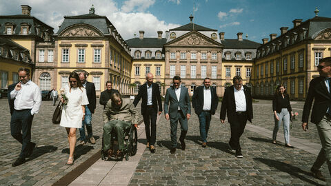 MP vor Ort in Nordhessen Eine Gruppe Menschen vor einem Schloss.
